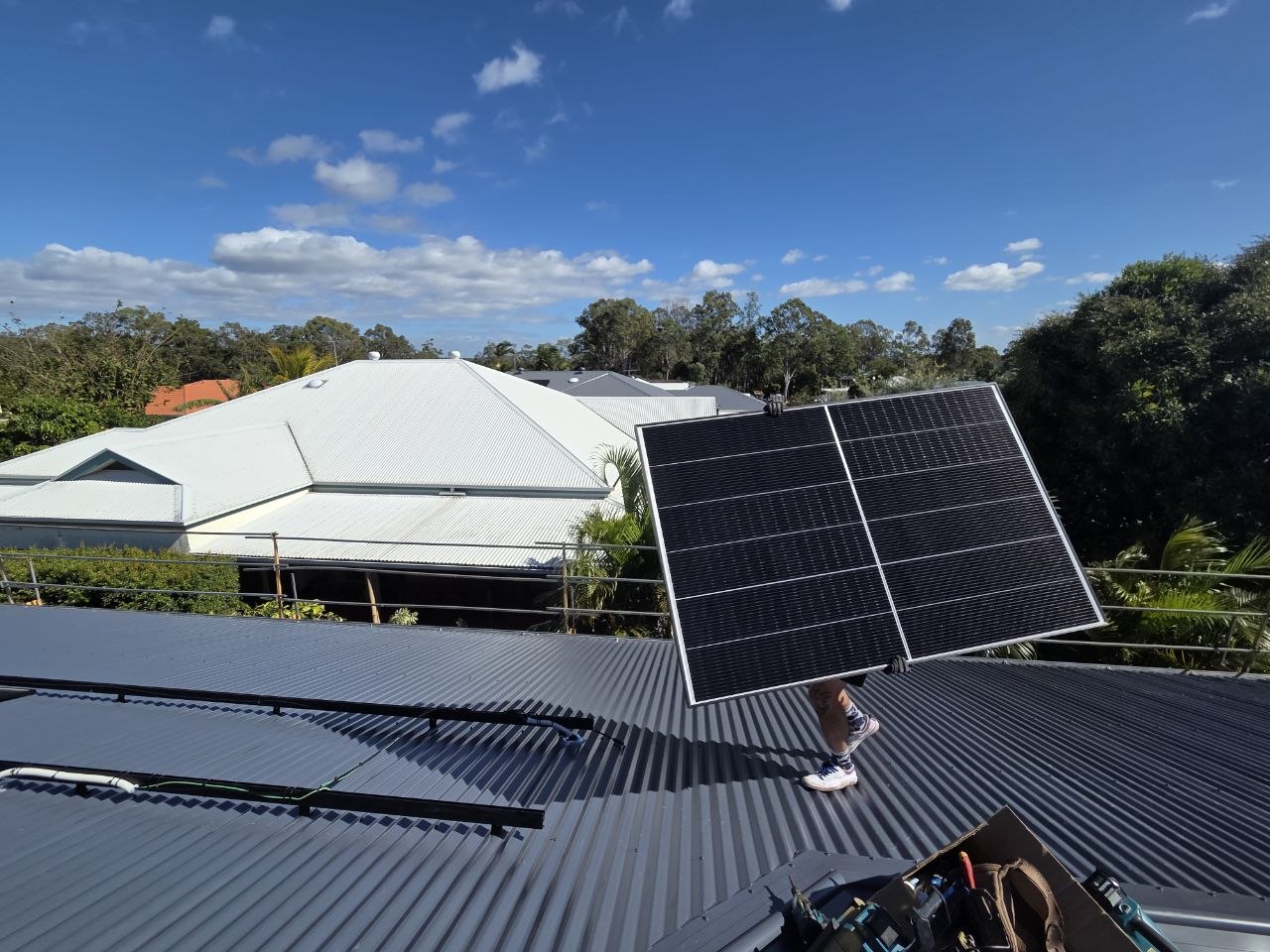 Solar panels on tilt frames installed on a metal roof