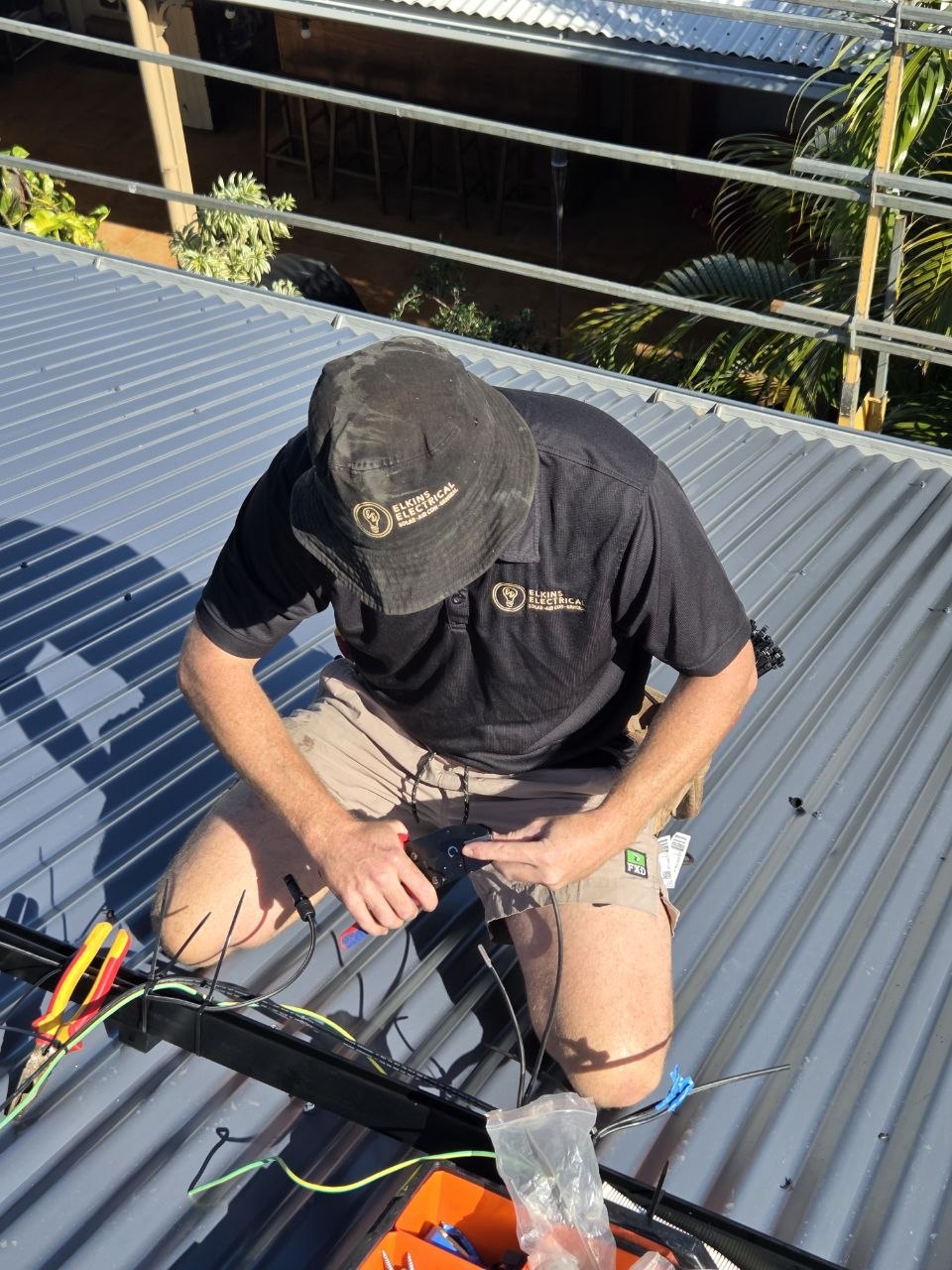 Elkins Electrical electrician running cabling for a rooftop solar install